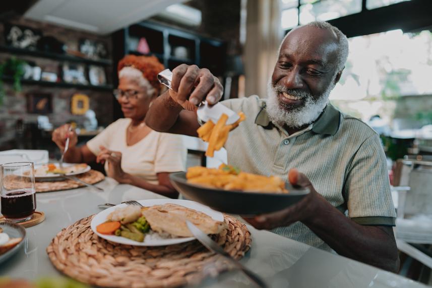Man putting food on his plate for dinner