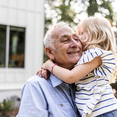 Grandpa and granddaughter hugging